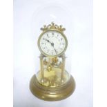 A good quality brass anniversary-style mantel clock with enamelled circular dial within glass