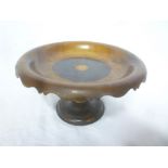 An unusual olive wood and rose wood circular comport with tapered stem and circular base