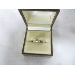 An 18ct gold wedding band inset with three diamonds