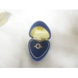 An 18ct gold dress ring set a sapphire surrounded by diamonds