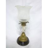 A Victorian brass oil lamp with clear glass reservoir and etched glass shade