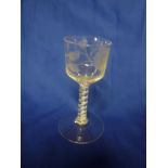 A George III wine glass etched with flowers and leaves, double air twist stem and circular base,