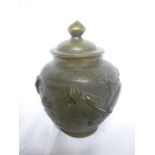 A Japanese bronze circular tapered vase and cover decorated in relief with dragons