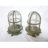 A pair of brass ships bulk-head lights with clear glass lenses