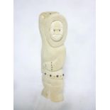 An unusual Eskimo Inuit carved bone figure, signed E Tockton,