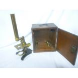 A good quality brass and painted metal monocular microscope in fitted case with accessories