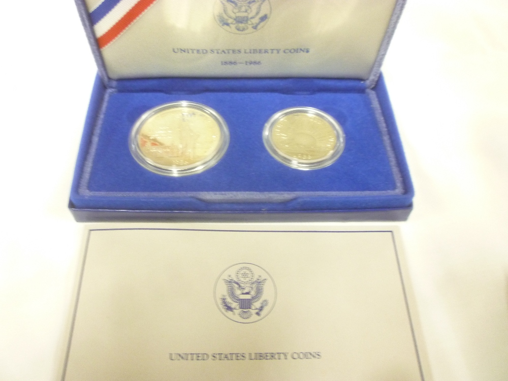 A United States Liberty silver proof dollar and half dollar coin set,