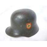 A rare First War German steel helmet with original liner and chin strap,