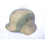 A Second War German M42 pattern steel helmet with painted Coastal Defence camouflage design and