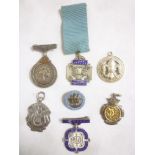 A selection of mainly silver medallions and badges including Woolworth's 21 Year Faithful Service