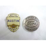 An enamelled motoring badge "Motor Exhibition Austin 39 Staff" and one other motoring badge "Model