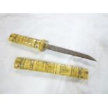 A Japanese tanto dagger with single edged blade and carved bone hilt with matching scabbard