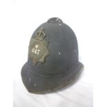 An old blue Police helmet with blackened Metropolitan Police badge "W647"