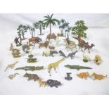 A selection of Britains and other painted lead zoo animals together with palm trees,