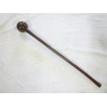 An old African hardwood knobkerry with spherical head and tapered shaft,
