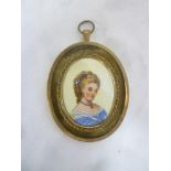 A miniature watercolour portrait on ceramic depicting bust portrait of female in gilt oval locket