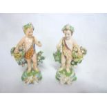 A pair of 19th Century china figures of cherubs with baskets of flowers,