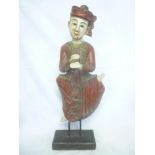 A 20th Century Eastern carved and painted wood dancing figure on wooden stand,