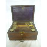 A Victorian rosewood rectangular toiletry box with part fitted interior including ink and scent