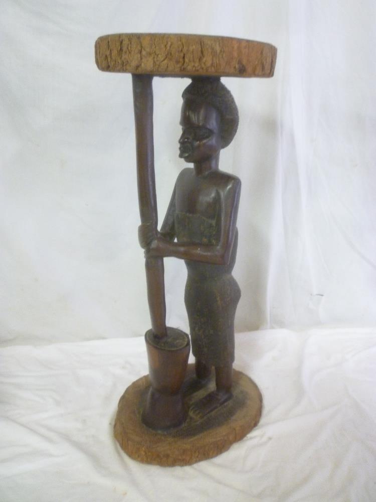 A good quality old African carved wood one-piece rustic table,