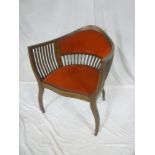 A late Victorian inlaid mahogany curved occasional chair with decorated back on scroll supports