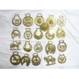 A set of 19th Century and later horse brasses of varying patterns including sun, crescent moon,