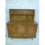 A 1960's Ercol light elm sideboard with cupboard enclosed by two panelled doors above a single