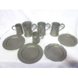 Three various 19th Century quart pewter tankards with side pouring lips and scroll handles,