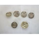 Four late Victorian matching silver dress buttons with floral decoration,