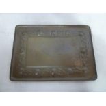 A Newlyn copper rectangular tea tray, the border decorated in relief with oranges and leaves,
