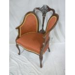 A late Victorian carved mahogany easychair with decorated splat back and red fabric upholstery on