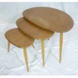 A nest of three 1960's Ercol light elm "Pebble" coffee tables