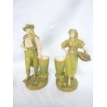 A pair of Royal Worcester china figures of a male and female with baskets of fruit,