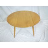 A 1960's Ercol circular coffee table on tapered legs 30" diameter