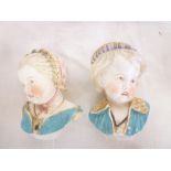 A pair of 19th Century china bust figures of children wearing hats,