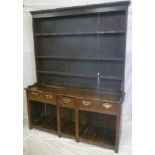 A George III oak farm house dresser with three drawers in the frieze above open pot boards,