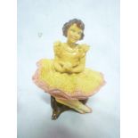 An early Wade pottery figure of a seated young ballerina