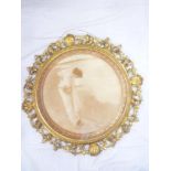 An Art Nouveau sepia circular print depicting a classical female on a shoreline in ornate gilt