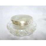 A George V cut glass circular powder jar with silver mounted lid,