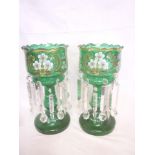 A pair of Victorian green-tinted glass table lustres with painted floral decoration and glass