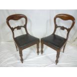 A set of six Victorian mahogany balloon back-style dining chairs with carved rail backs and