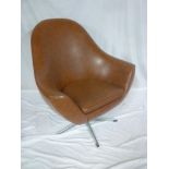 A 1960's brown vinyl swivel easy chair on chromium plated stand