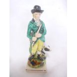 A 19th Century Staffordshire pottery figure of a hunter with dog on square base,