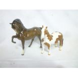 A Beswick china figure of a brown stallion and one other Beswick china figure of a skewbald pony