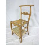 An unusual Continental walnut occasional chair with hinged cane work seat converting to a prayer