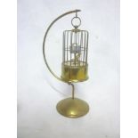 An unusual brass bird cage automaton-style clock with arched hanging support