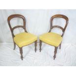 A set of eight Victorian mahogany arched back dining chairs with rail backs and upholstered seats