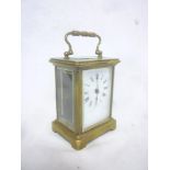 A French carriage clock with enamelled rectangular dial in brass traditional glazed case