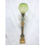 A large Victorian brass Corinthian column oil lamp with cut glass clear reservoir and green tinted