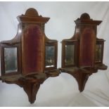 A pair of Victorian rosewood wall display shelves with central velvet lined arched niches,